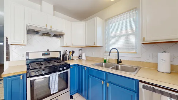a kitchen with stainless steel appliances a refrigerator sink and cabinets