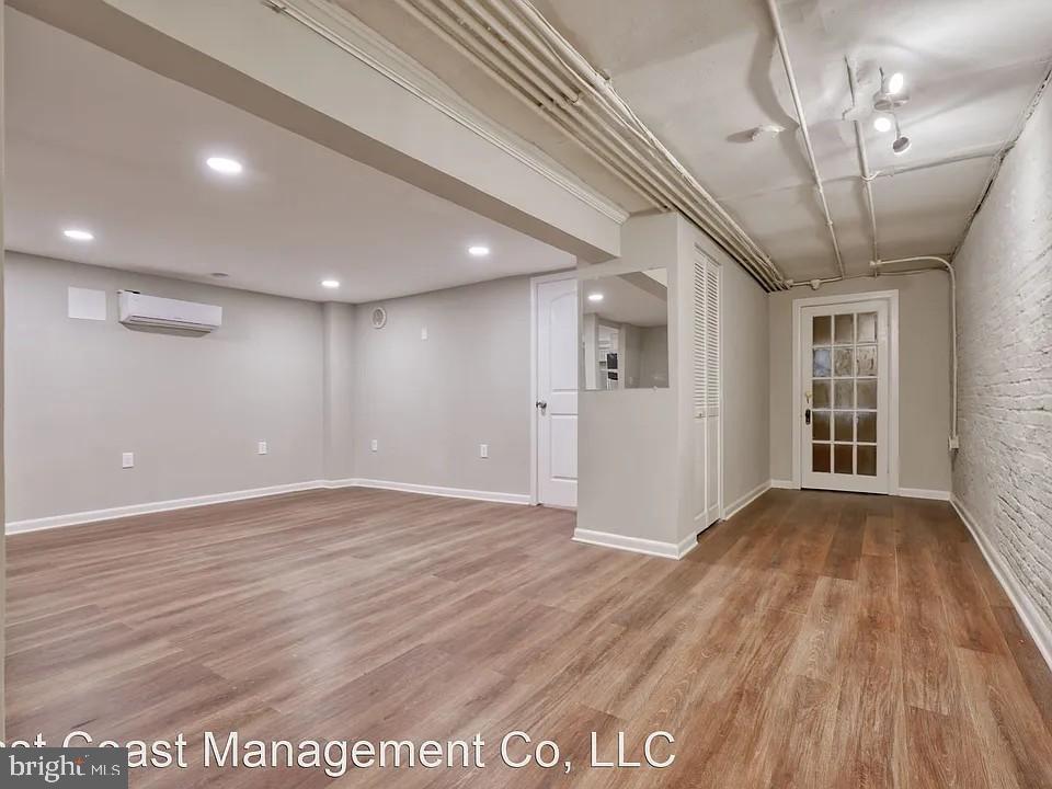 917 North Calvert Street, Unit 1 Baltimore, MD 21202 - Photo 1 of 24 a view of an empty room with wooden floor and a window