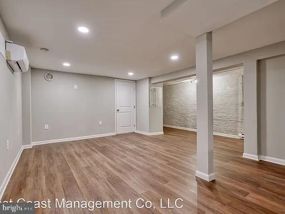 917 North Calvert Street, Unit 1 Baltimore, MD 21202 - Photo 16 of 24 a view of an empty room with wooden floor and a bathroom