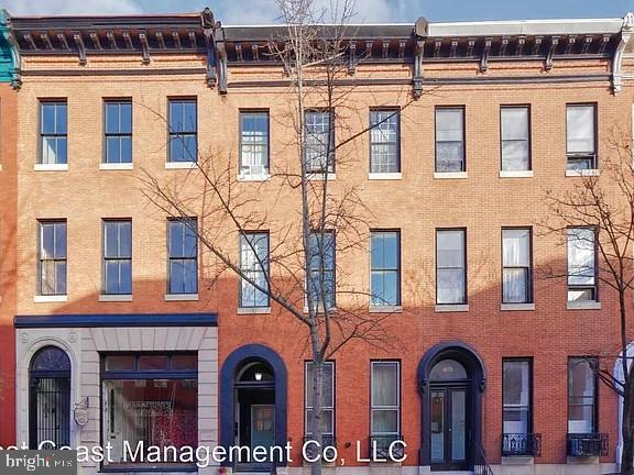 917 North Calvert Street, Unit 1 Baltimore, MD 21202 - Photo 2 of 24 front view of building with a brick building