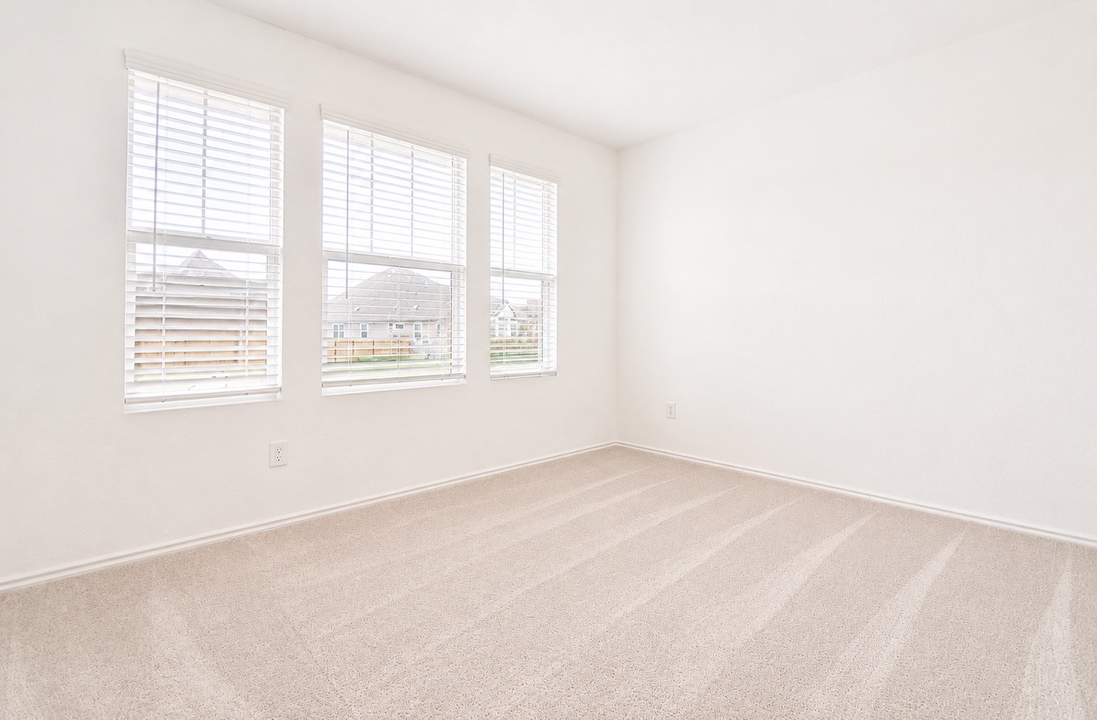 397 Keefer Kyle, TX 78640 - Photo 25 of 33 A well-lit bedroom with fresh, neutral carpet and ample natural illumination.