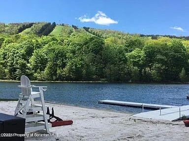 a view of a lake with chairs