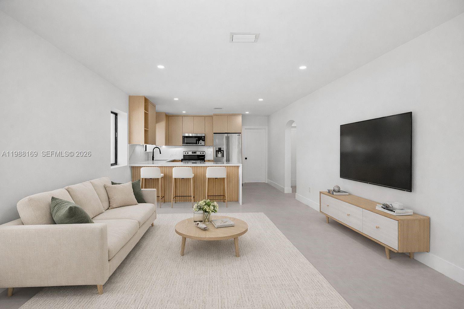 421 Northwest 81st Street Miami, FL 33150 - Photo 11 of 39 a living room with furniture and a flat screen tv