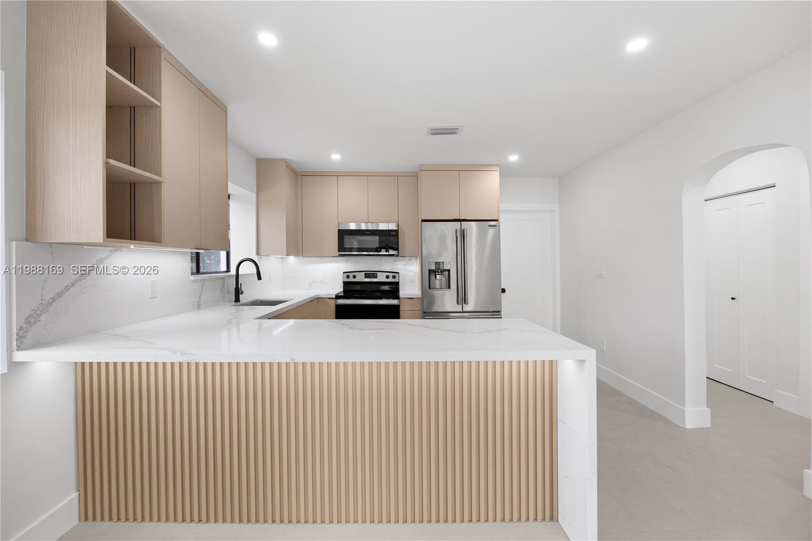 421 Northwest 81st Street Miami, FL 33150 - Photo 12 of 39 a kitchen with stainless steel appliances a refrigerator and a sink
