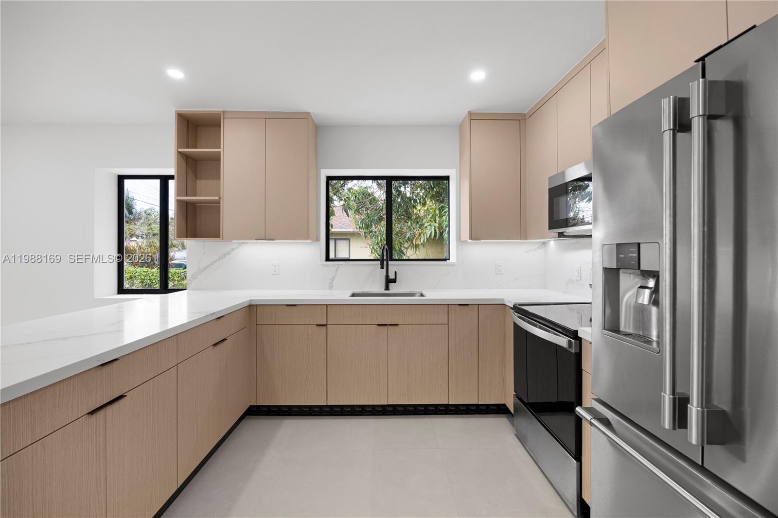 421 Northwest 81st Street Miami, FL 33150 - Photo 14 of 39 a kitchen with white cabinets and a refrigerator