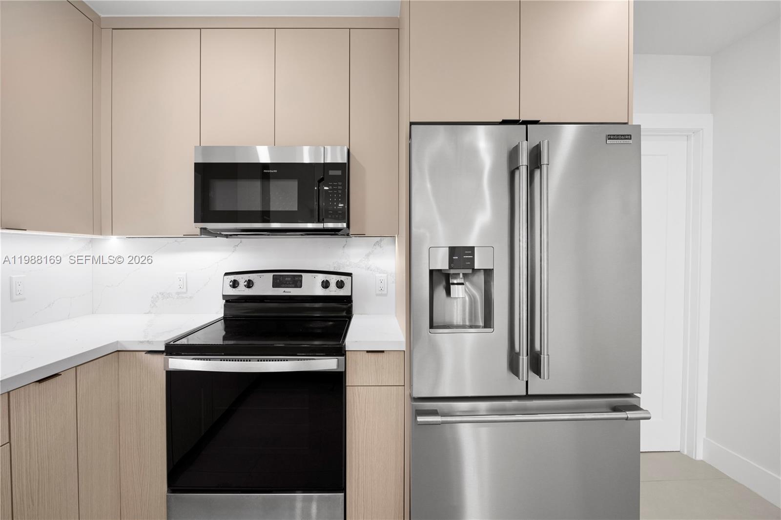 421 Northwest 81st Street Miami, FL 33150 - Photo 15 of 39 a kitchen with a refrigerator stove and microwave