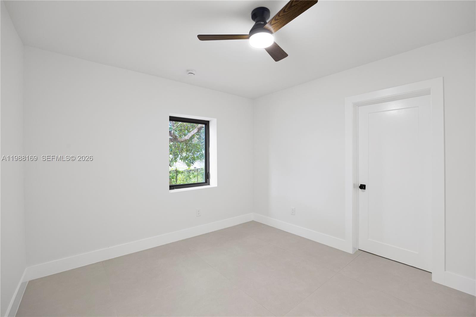421 Northwest 81st Street Miami, FL 33150 - Photo 18 of 39 an empty room with a window and a ceiling fan
