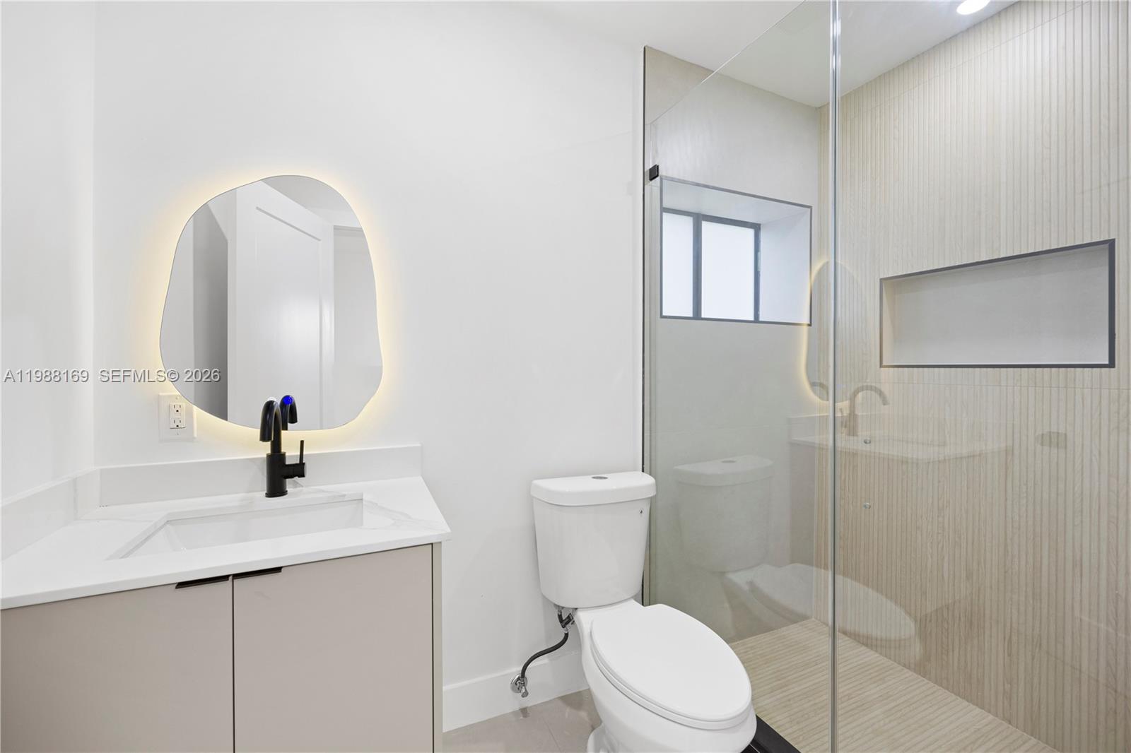 421 Northwest 81st Street Miami, FL 33150 - Photo 25 of 39 a bathroom with a toilet a sink and mirror