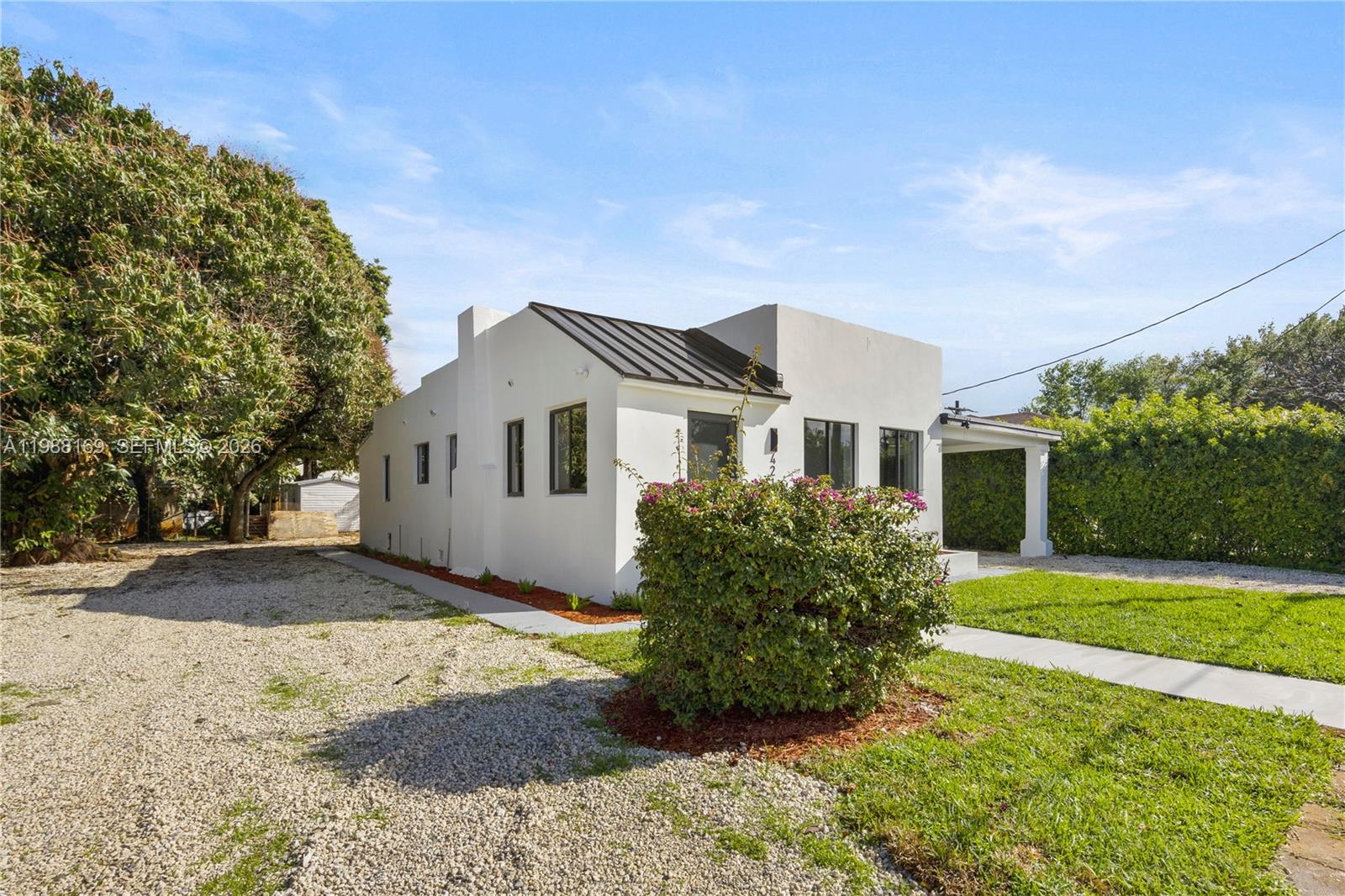 421 Northwest 81st Street Miami, FL 33150 - Photo 3 of 39 a view of a yard in front of a house with a large tree