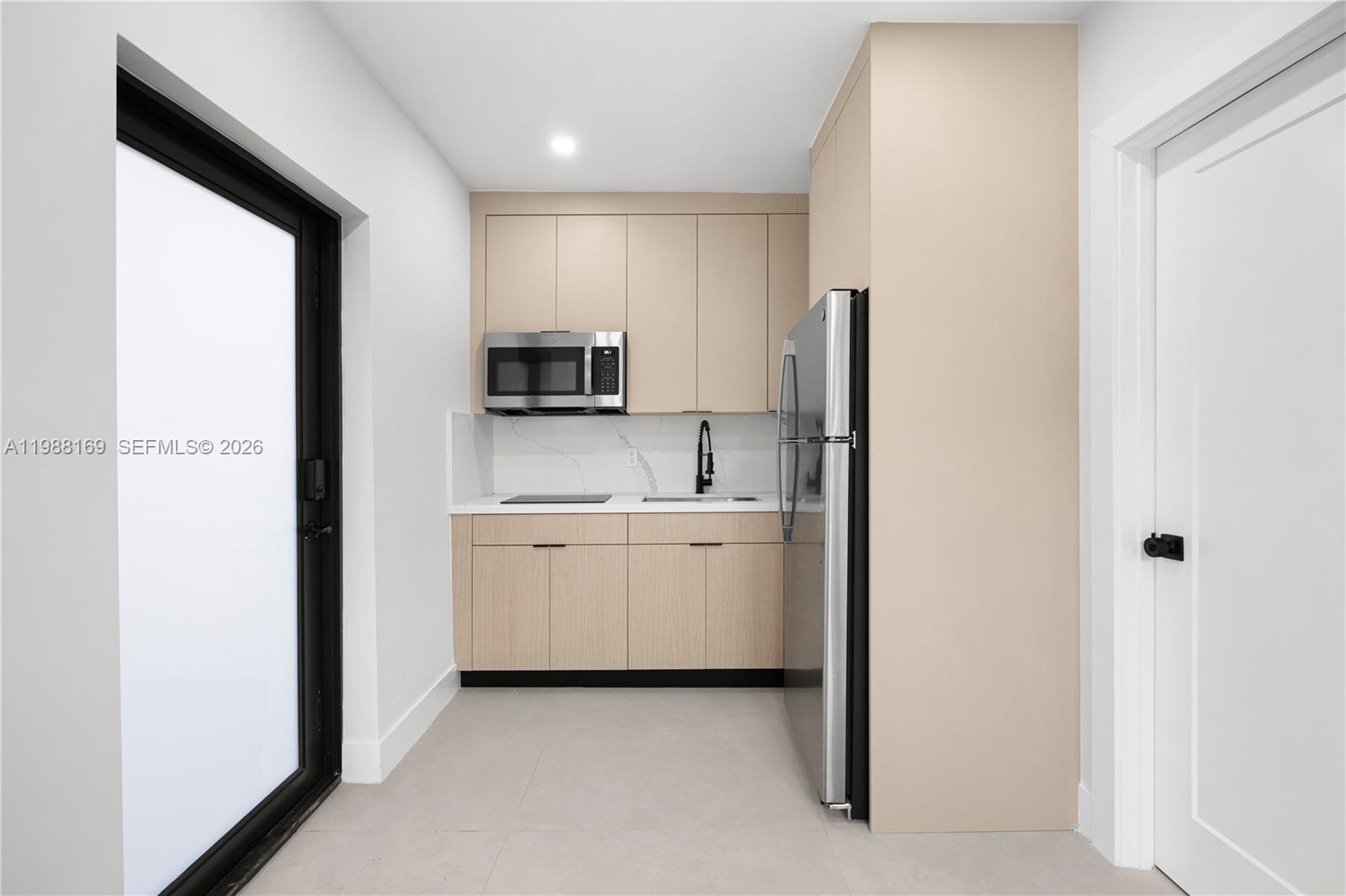 421 Northwest 81st Street Miami, FL 33150 - Photo 32 of 39 a kitchen with appliances a sink and cabinets