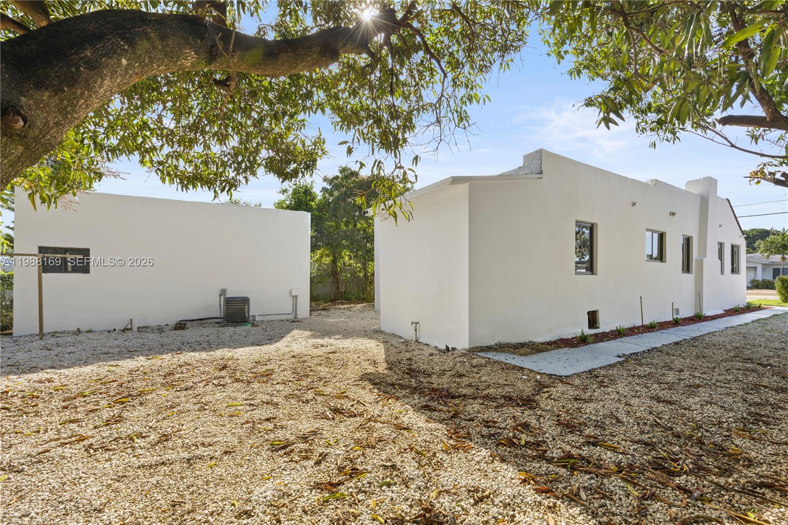 421 Northwest 81st Street Miami, FL 33150 - Photo 4 of 39 a view of a white house with a yard and large tree