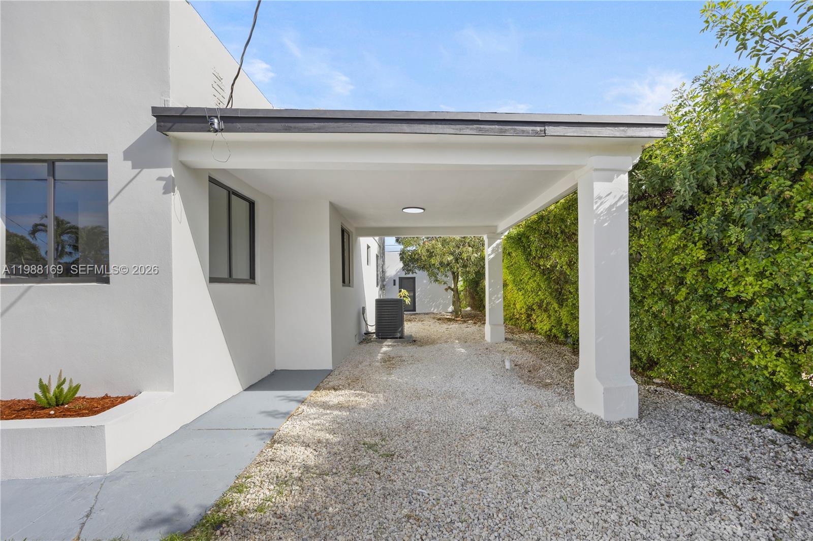 421 Northwest 81st Street Miami, FL 33150 - Photo 8 of 39 a view of a patio with table and chairs and potted plants