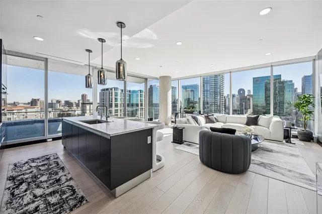 a large kitchen with stainless steel appliances kitchen island granite countertop a lot of cabinets and wooden floor