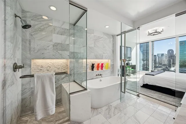 a white bed sitting in a bedroom next to a window