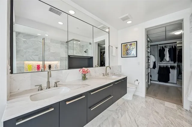a bathroom with a sink double vanity and a shower
