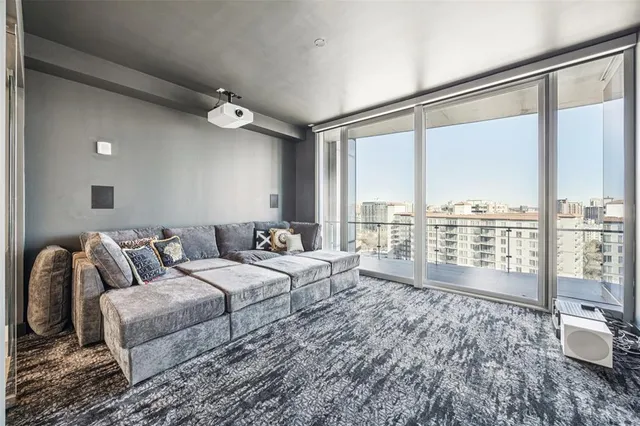 a bedroom with a bed couch and a large window