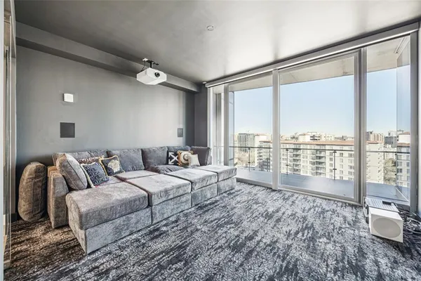 a bedroom with a bed couch and a large window
