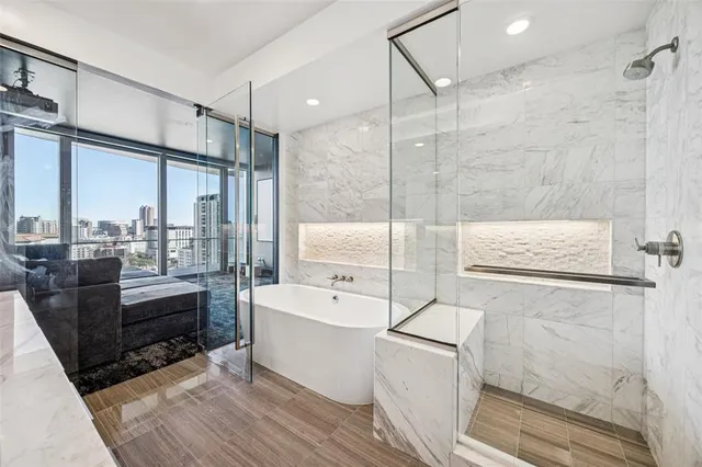 a bathroom with a double vanity sink a toilet a mirror and shower