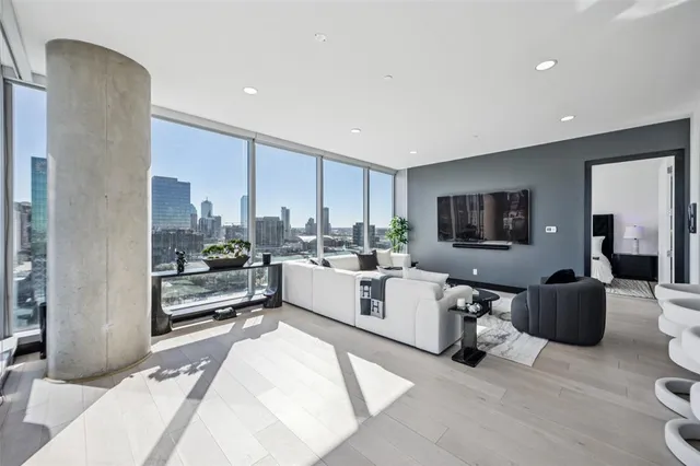 a living room with furniture a rug and a flat screen tv