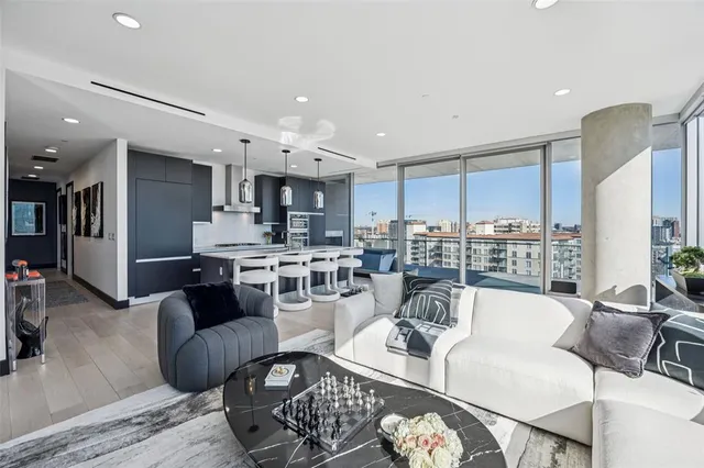 a living room with lots of furniture and kitchen view