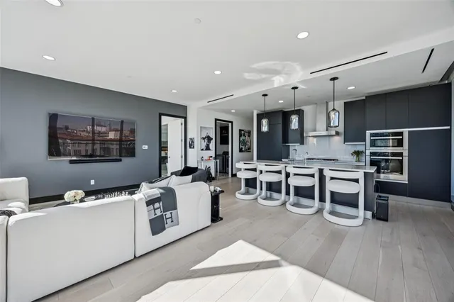 a living room with furniture a wooden floor and window