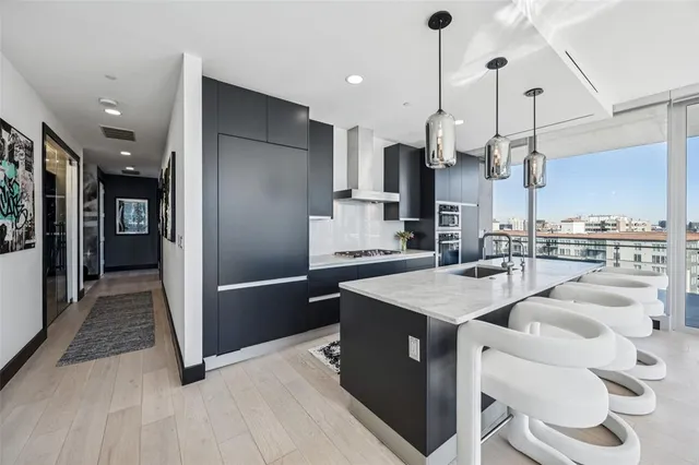 a kitchen with kitchen island sink stove and refrigerator