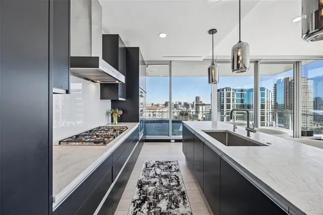 a kitchen with stainless steel appliances granite countertop a sink stove and refrigerator