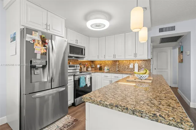 a kitchen with a refrigerator and a sink