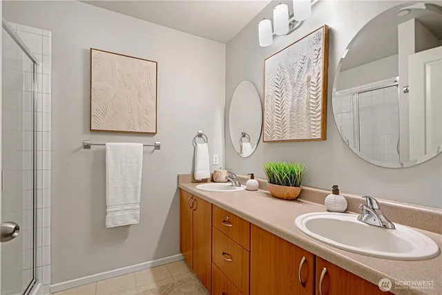 a bathroom with a double vanity sink and a mirror
