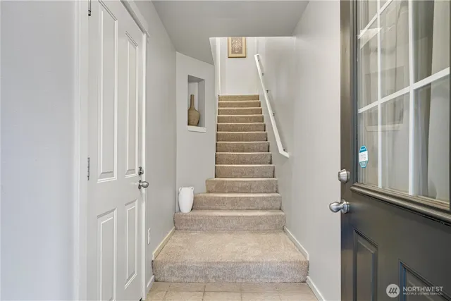 a view of staircase with white walls and windows