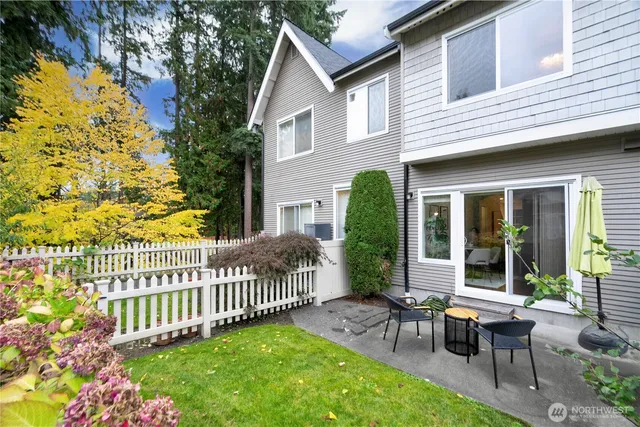 a view of a house with a small yard and wooden fence