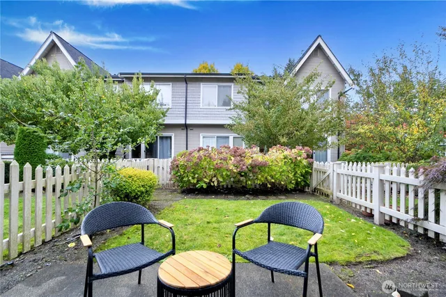 a view of a chairs and table in backyard