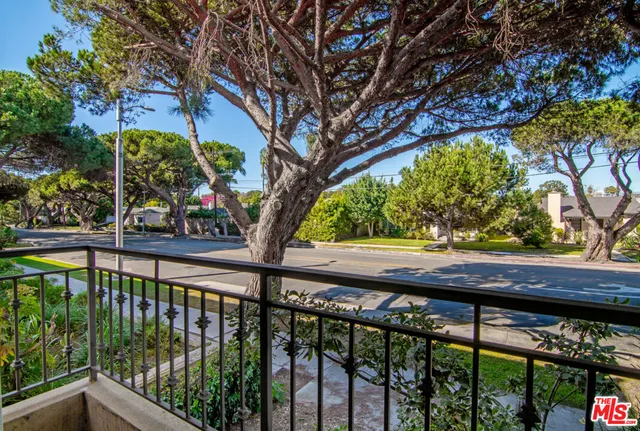 a view of a balcony with a tree