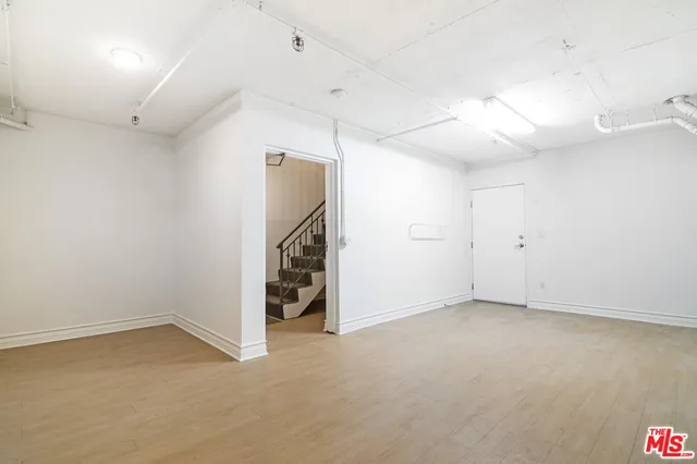 an empty room with a empty space and a ceiling fan