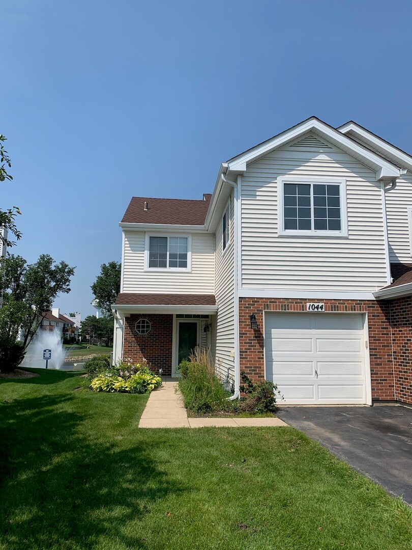 1044 Ripple Ridge Darien, IL 60561 - Photo 1 of 1 a front view of a house with a yard and garage