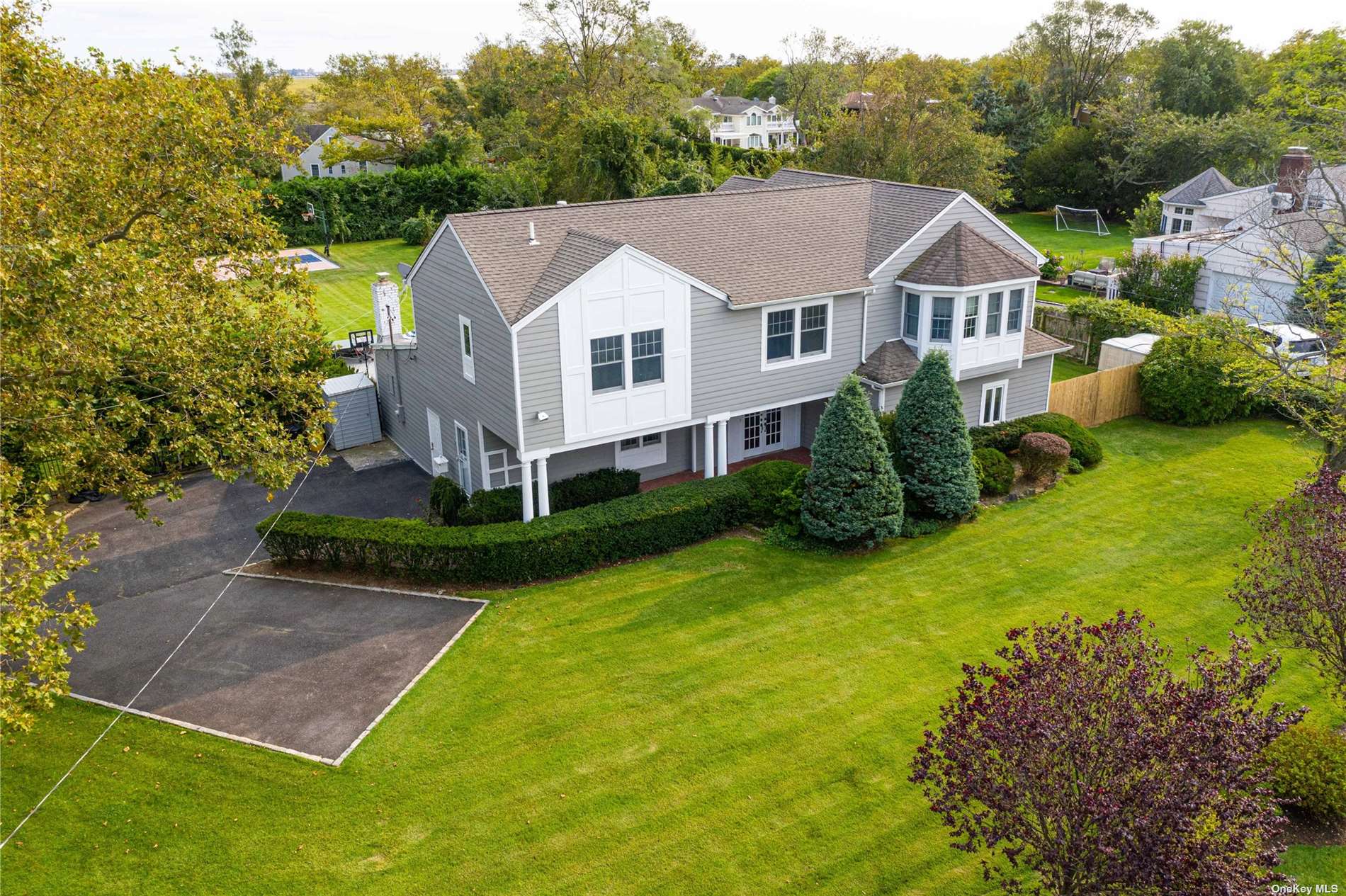 a aerial view of a house with yard and a patio