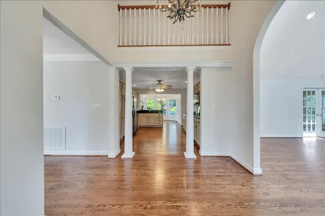 a spacious bedroom with a bed a dresser and a window