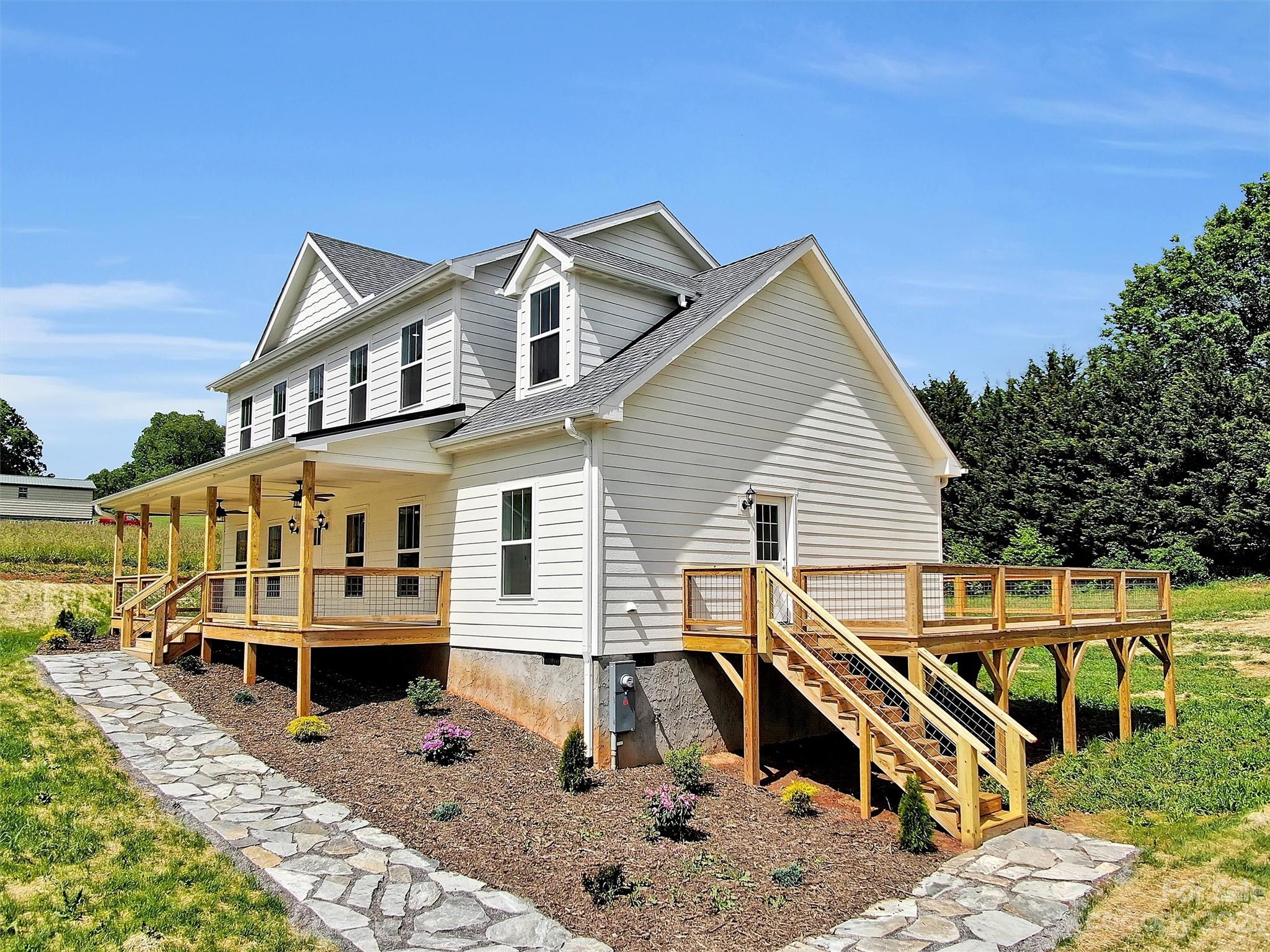 a view of a house with wooden deck