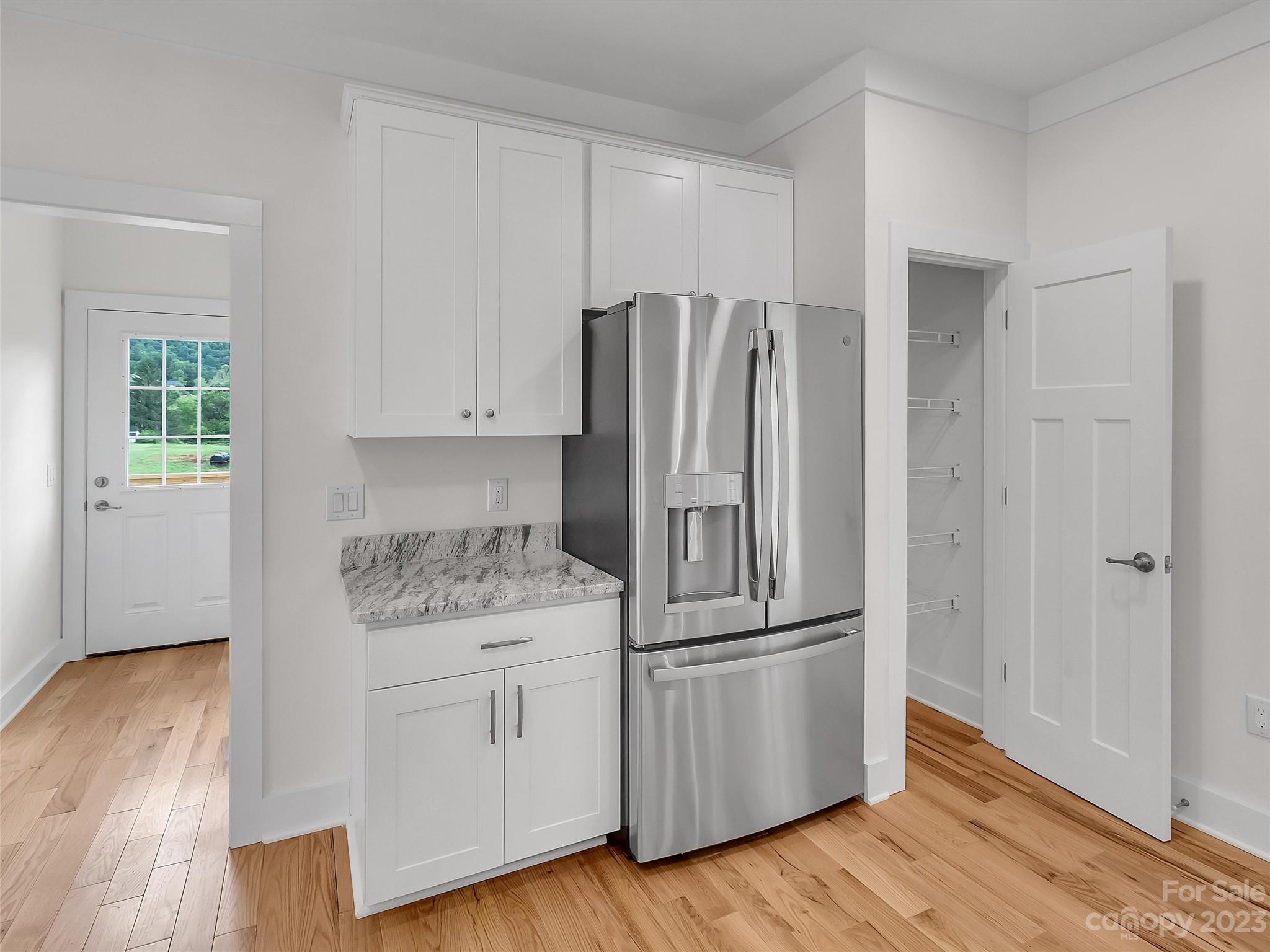 160 Rdg Vw Drive, Unit 21 Clyde, NC 28721 - Photo 15 of 39 a kitchen with appliances wooden floor and a window