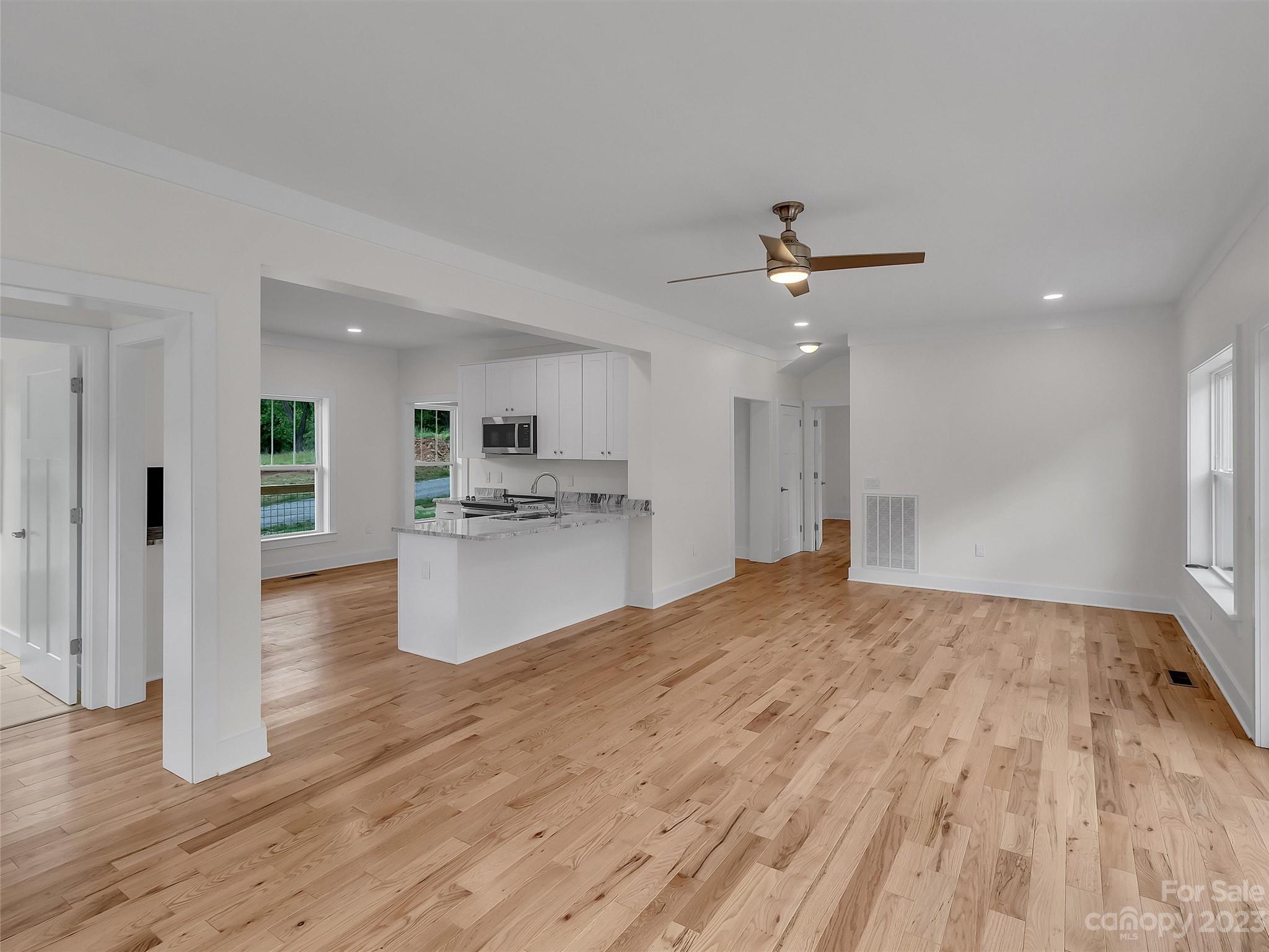 160 Rdg Vw Drive, Unit 21 Clyde, NC 28721 - Photo 17 of 39 a view of a kitchen with kitchen island wooden floor center island and stainless steel appliances