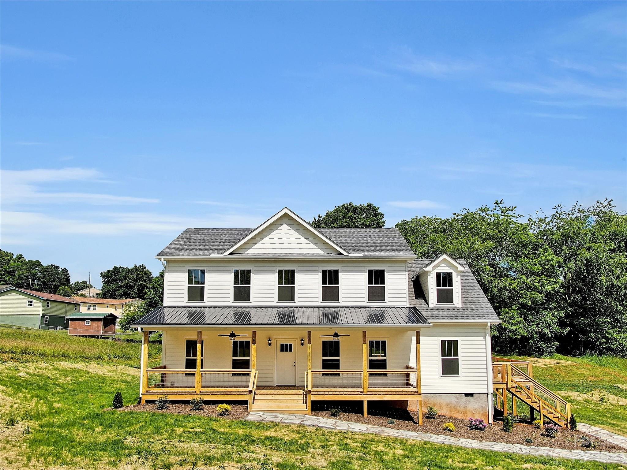 160 Rdg Vw Drive, Unit 21 Clyde, NC 28721 - Photo 2 of 39 a front view of a house with a yard