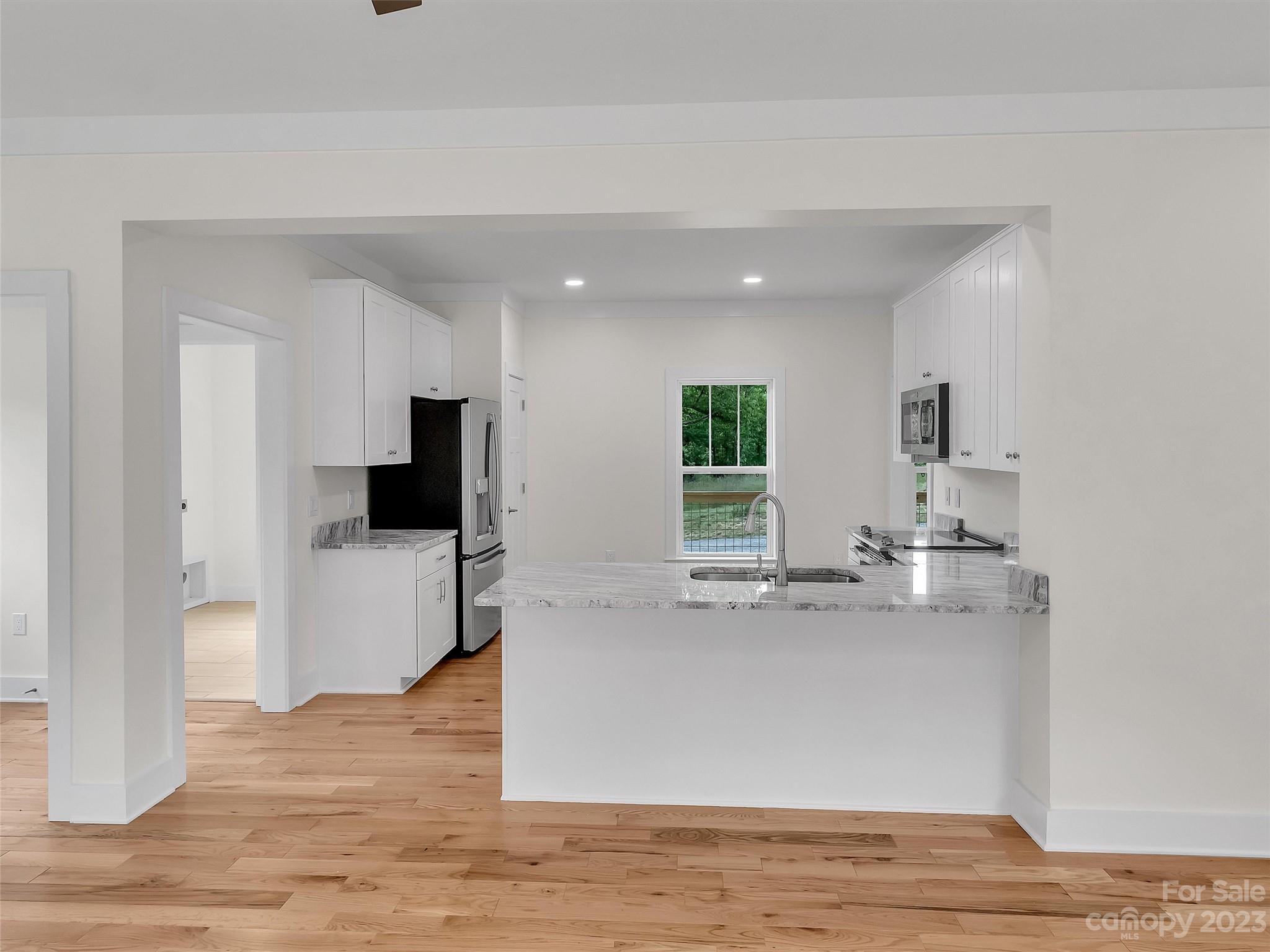 160 Rdg Vw Drive, Unit 21 Clyde, NC 28721 - Photo 21 of 39 a view of living room kitchen with stainless steel appliances kitchen island sink and refrigerator