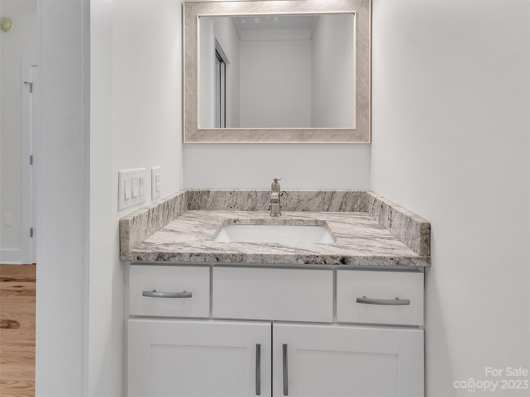 160 Rdg Vw Drive, Unit 21 Clyde, NC 28721 - Photo 26 of 39 a bathroom with a granite countertop sink and vanity