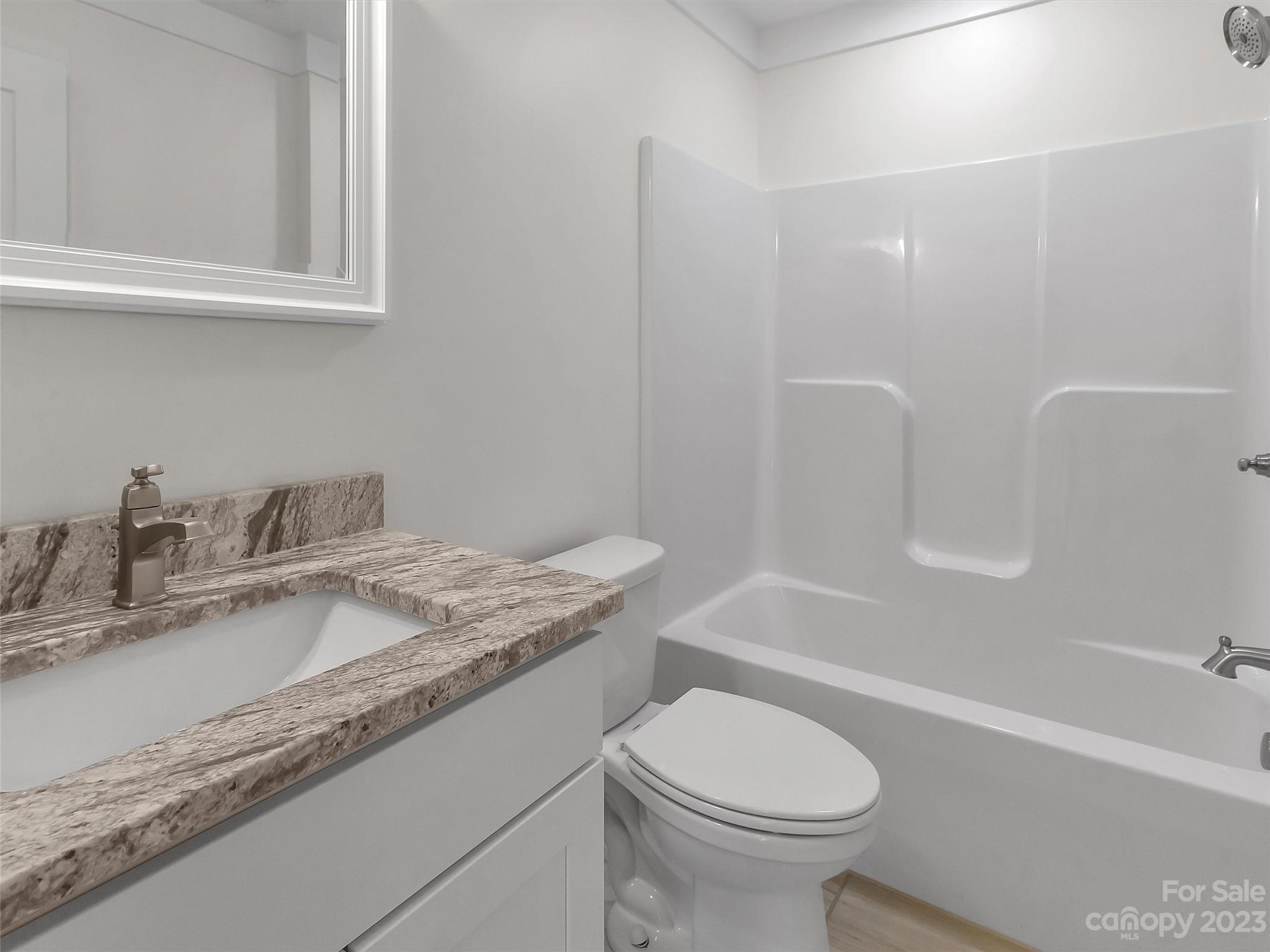 160 Rdg Vw Drive, Unit 21 Clyde, NC 28721 - Photo 28 of 39 a bathroom with a granite countertop sink toilet and shower