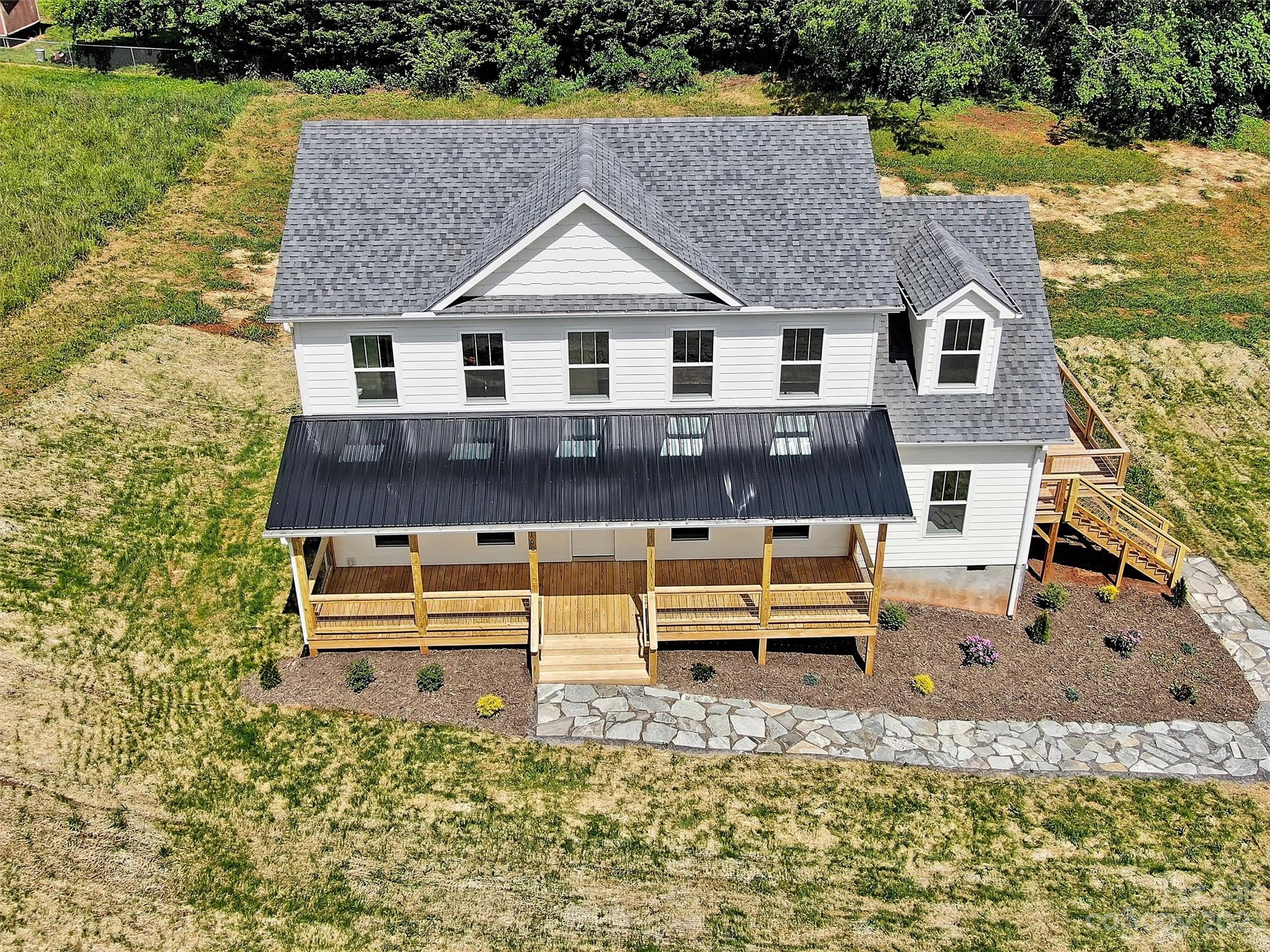 160 Rdg Vw Drive, Unit 21 Clyde, NC 28721 - Photo 3 of 39 a front view of a house with a yard