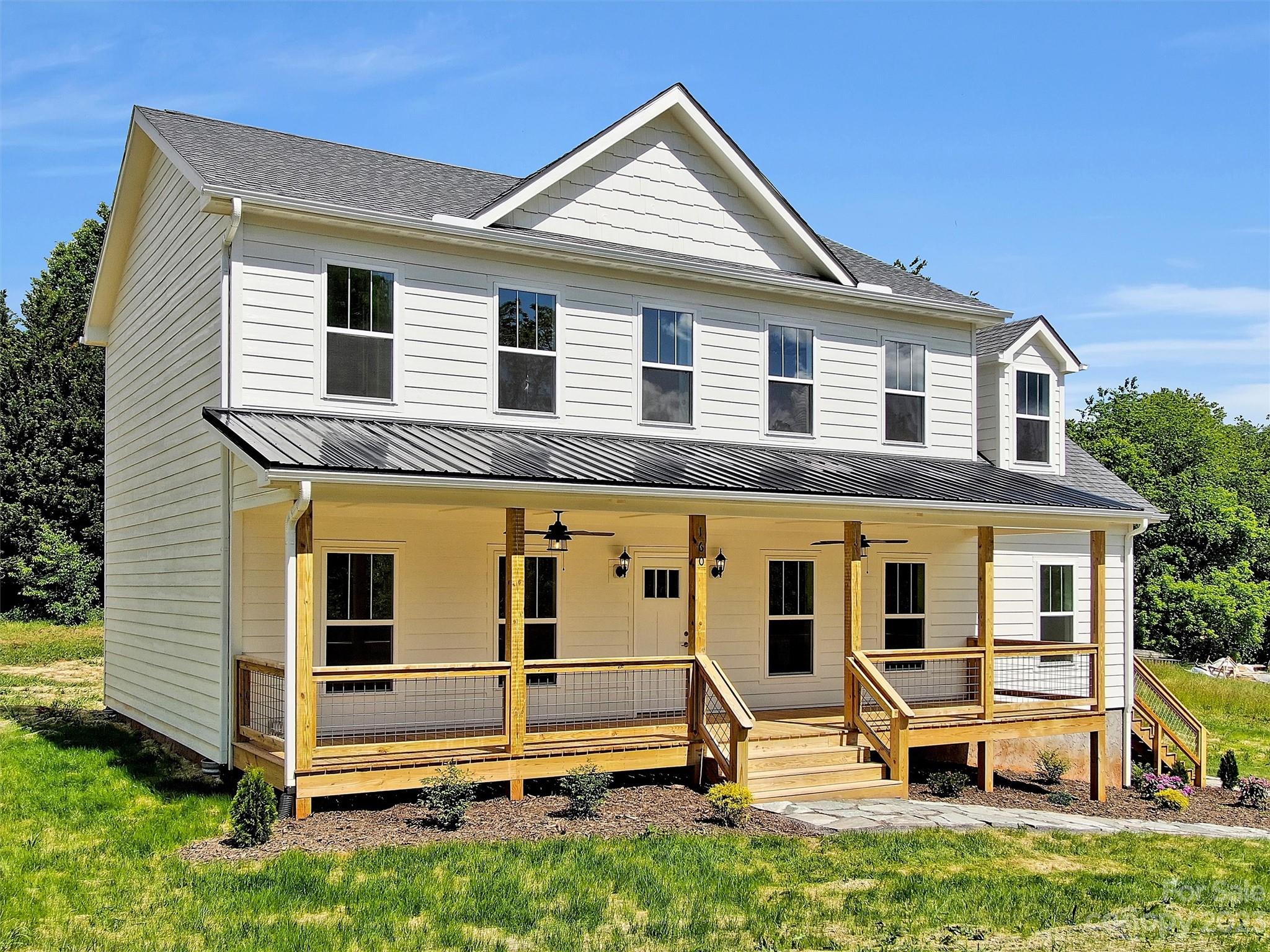 160 Rdg Vw Drive, Unit 21 Clyde, NC 28721 - Photo 8 of 39 a front view of a house with a yard