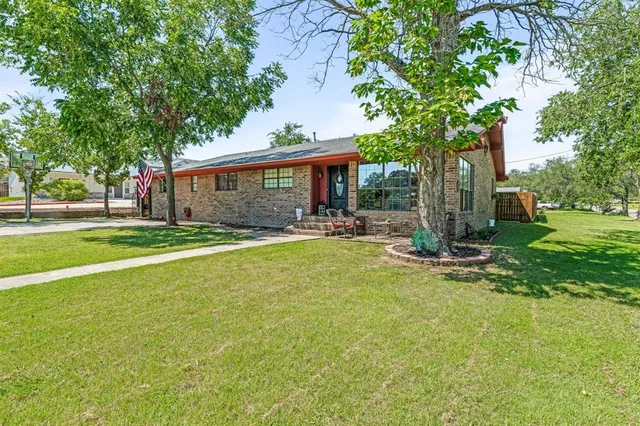 a front view of house with yard and green space