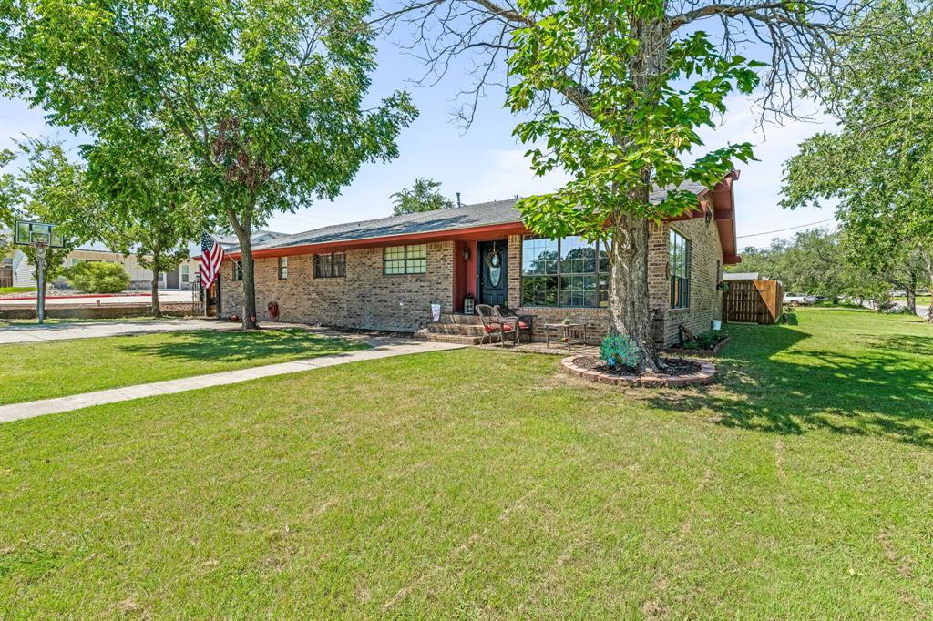 a front view of house with yard and green space