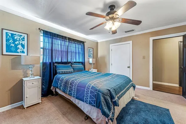a spacious bedroom with a bed and a chandelier