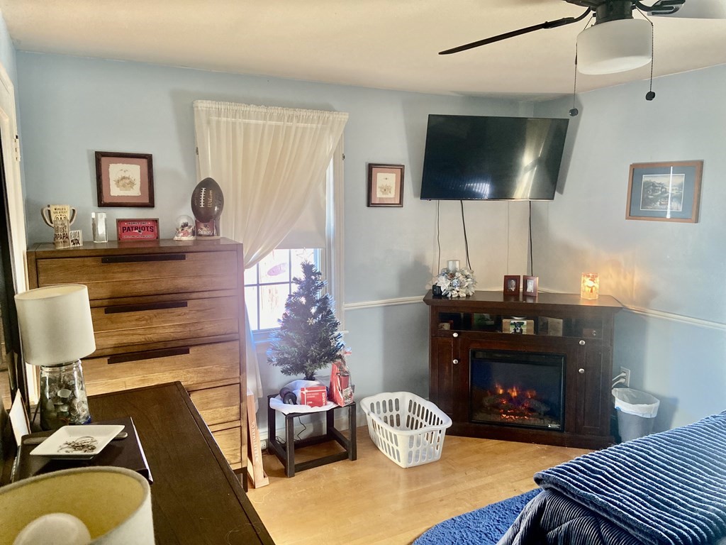 44 Brewster Road Waltham, MA 02451 - Photo 15 of 31 a living room with furniture and a flat screen tv